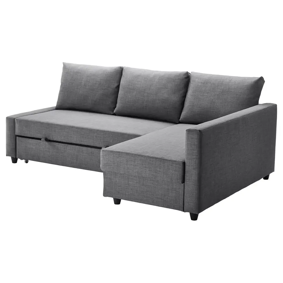 Dark grey corner sofa bed with a chaise longue on the right and three back cushions, on a white background